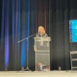 Deborah Crawford speaking at a podium